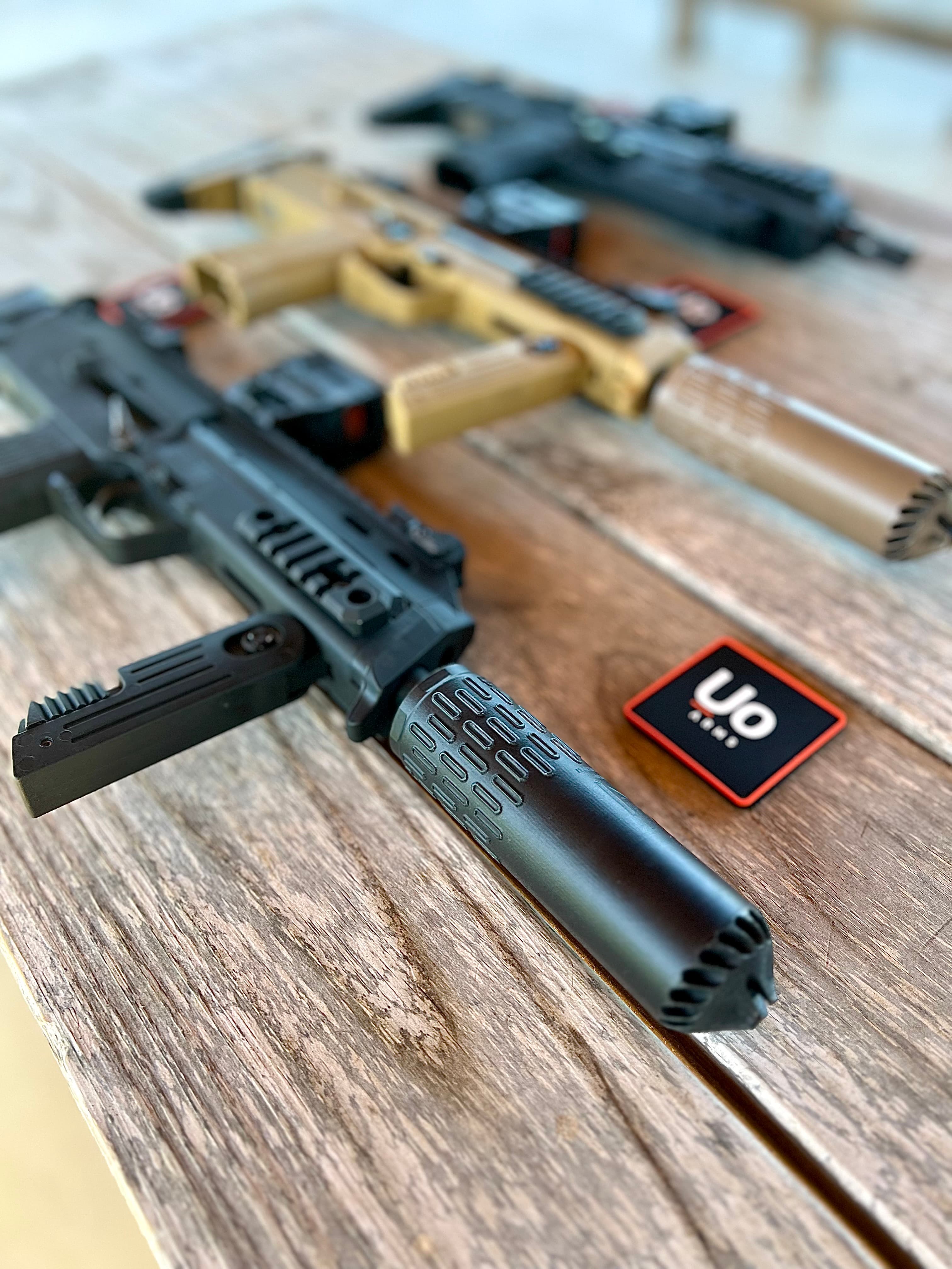 NT7 on a table with Uo Arms logo